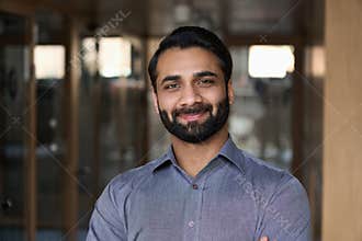 Portrait of young happy indian business man executive looking at camera.