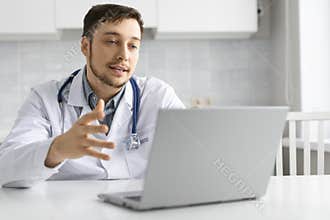 Photo of a doctor talks to the patient during an online consultation.