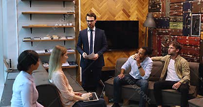 Confident ceo executive manager holding briefing meeting with diverse employees.