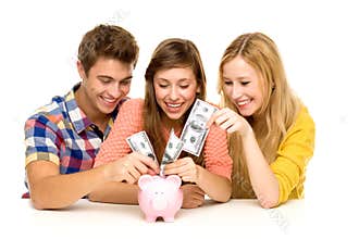 Friends putting money in piggy bank