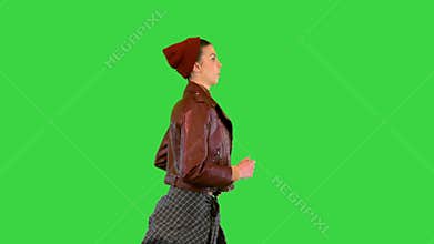 Girl wearing leather jacket running on a Green Screen, Chroma Key.
