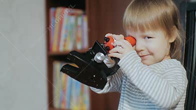 Home Science Tool Kids Microscope. Child development. Toddler playing with a microscope.