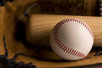Baseball and baseball bat in glove