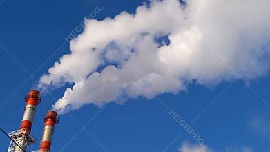 Fabric chimneys smoking in blue sky. Air pollution concept