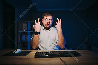Funny crazy freelancer gets angry from night work, emotionally gestures with a crazy face looking up. Emotional man is furious