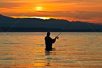 Silhouette of a fisherman at sunset.