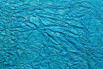 A beautiful cyan color handmade paper of crumple or wrinkle texture with veins and fibers.