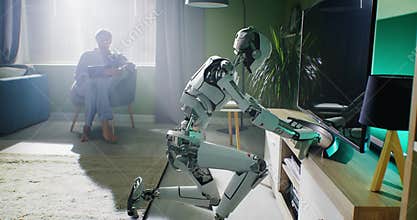 Robotic housekeeper wiping dust near owner