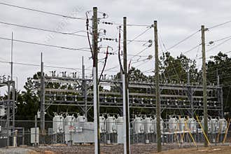 A power station and security fence with warning signs