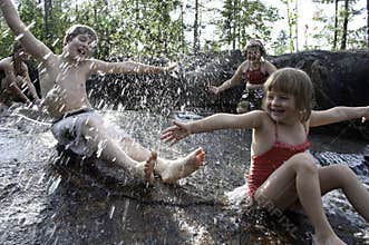 Children playing in waterfall