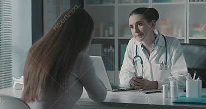 Doctor comforting a woman crying during a visit