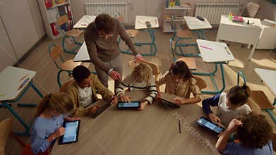 Students doing class work on digital tablets. Pupils using tablet computers