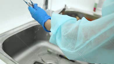 Cleaning, sterilization and disinfecting medical tools instruments dentistry. clinic assistant washing dentist tools with brush