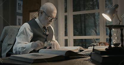 Senior academic researcher working in his office