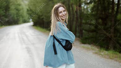 Happy woman walking road in forest, excited, emotional