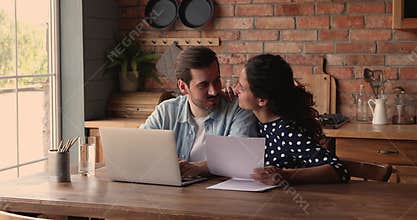 Happy young married couple reading paper document.