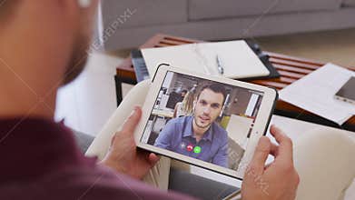 Businessman doing video call with colleague from home
