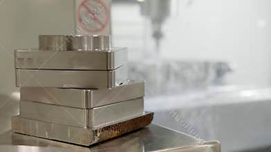 Metal parts and an automatic metal working machine in the factory.