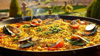 Steam coming out of seafood and noodles paella