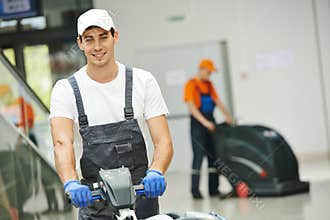 Male worker cleaning business hall
