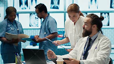 Healthcare experts in a treatment center analyzing x ray scans and test results