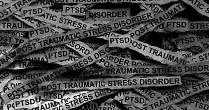 Strips of newspaper with the words Post Traumatic Stress Disorder typed on them.