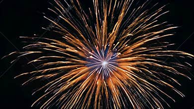 Big fireworks in the night sky, displaying a radiant point of light emerging from its core