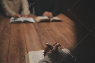 Christian group are praying to god with the bible and sharing the gospel. Concept of faith for god