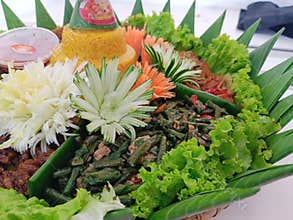 Tumpengan served with a variety of side dishes that are usually served for certain events is typical of Infonesia