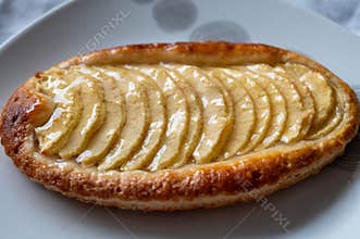 French fresh baked sweet puff pastry with fresh apple fruits in sirup in confectionery shop