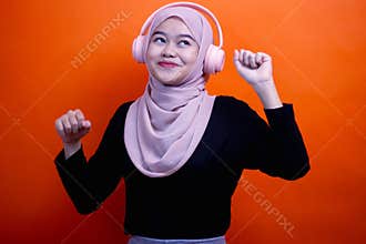 young asian woman hijab Listening music with headphones