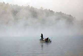 Boat fishing in the fog