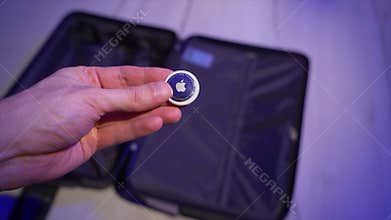 Apple Airtag in travel case for baggage tracking.