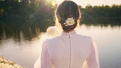 happy woman turns around looking at camera with love, vintage white dress old style. Noble girl beautiful smiling face
