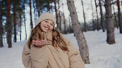 Young Girl Smiling Happily in a Snowy Forest During Winter