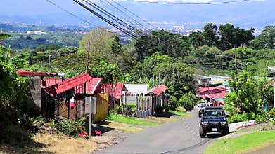 Village road street through land forest town mountains Costa Rica