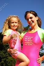 Child and swimming coach in pink