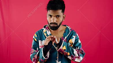 Quit smoking concept man broke cigarettes with hands and saying no gesture against red background