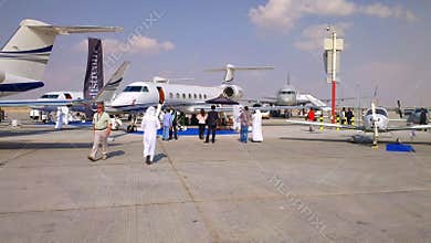 Dubai, UAE - 11.18.2013 - Visitors, exhibitors, participants at Dubai World Central Airport during Air show. Various aircraft and