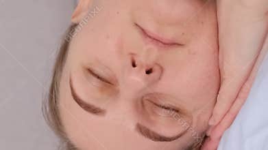 A tired woman falls asleep on the bed. A sound sleep. Vertical video