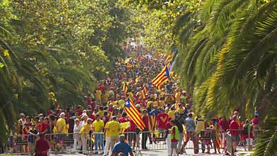 Crowd of People with Catalan Flags on the Street