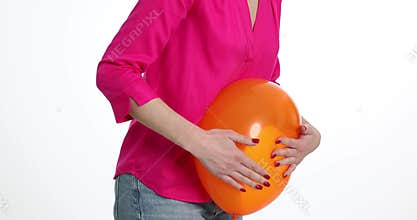Woman holds on to sick stomach with a balloon on white background