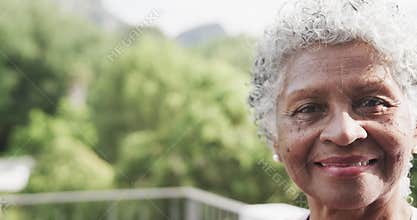 Portrait of happy senior african american woman smiling in garden, copy space, slow motion