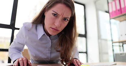 Businesswoman typing on computer keyboard and looking at camera with suspicion 4k movie slow motion