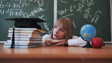 Blonde schoolgirl with bangs poses in front of school objects.