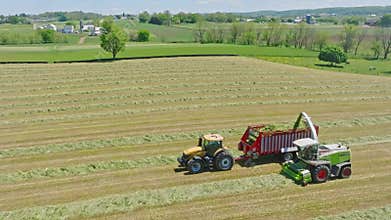 Harvest Dance: Tractors Bale Hay in Golden Fields with azure skies