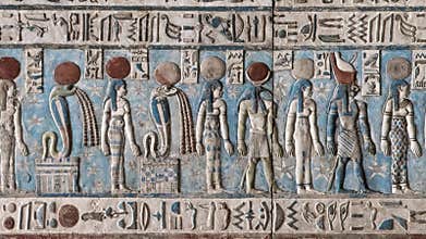 Ancient Egyptian hieroglyphs and bas-reliefs close-up in Dendera temple or Temple of Hathor. Egypt. Dendera Temple