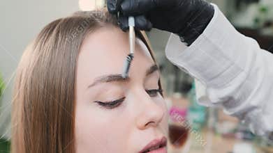 Eyebrow artist applies foam to cleanse before procedure