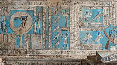 Ancient Egyptian hieroglyphs and bas-reliefs close-up in Dendera temple or Temple of Hathor. Egypt. Dendera Temple