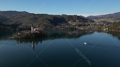 Electric boat sailing towards Lake Bled island aerial